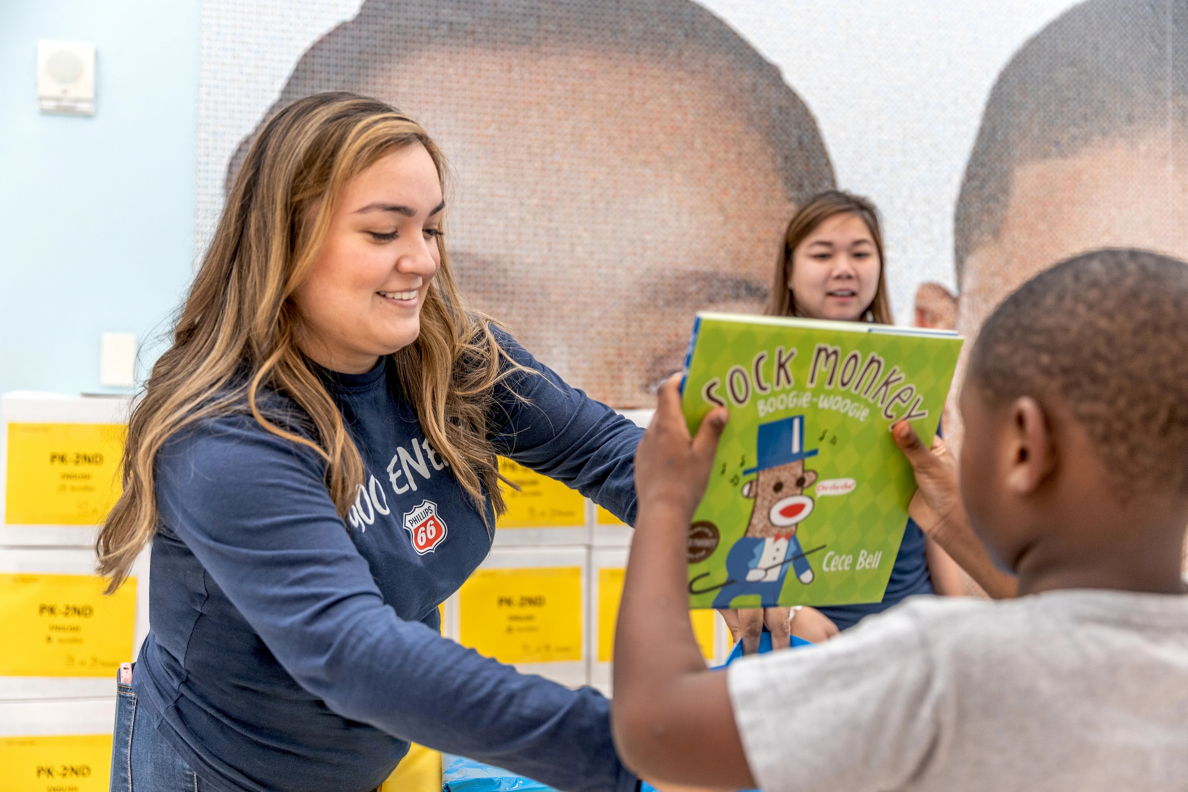Volunteer at the Barbara Bush Literacy night at the Children's Museum of Houston, where Phillips 66 donated mini-libraries to all children at the free family night.